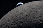 Close-up image of the Moon with the Earth in the background.
